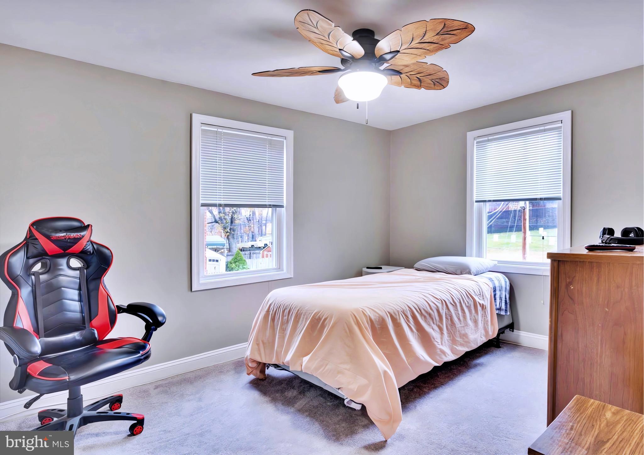 65 Garden Ridge Road Catonsville, MD 21228 - Photo 10 of 19 a bedroom with a bed and a chandelier