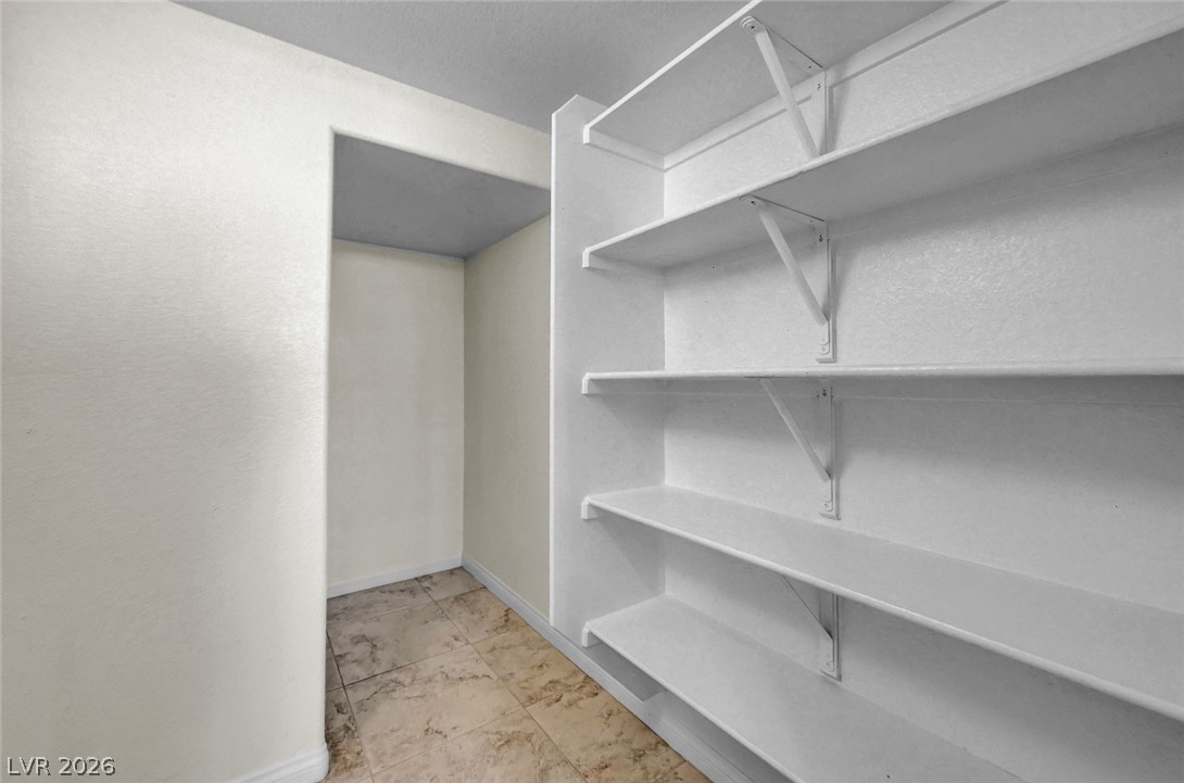 977 Sparkling Light Street Henderson, NV 89052 - Photo 36 of 75 This spacious closet features ample shelving and durable tile flooring.