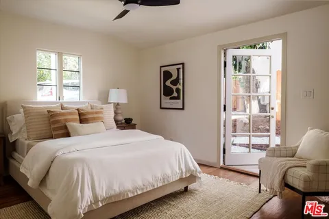 a spacious bedroom with a bed and glass window