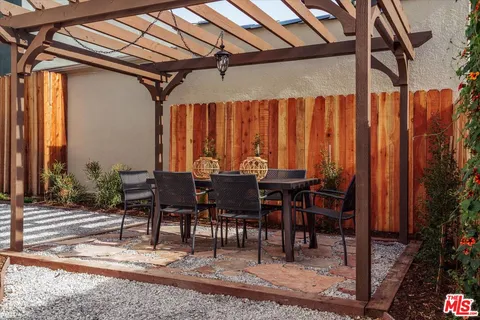 a view of a dinning table and chairs in patio
