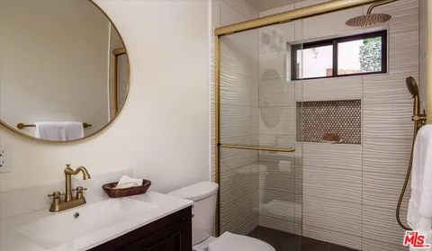a bathroom with a sink mirror and toilet