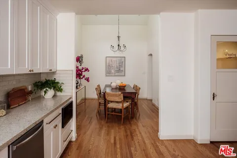a dining room with furniture and wooden floor