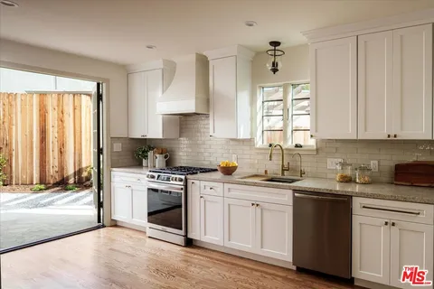 a kitchen with a sink stove and cabinets