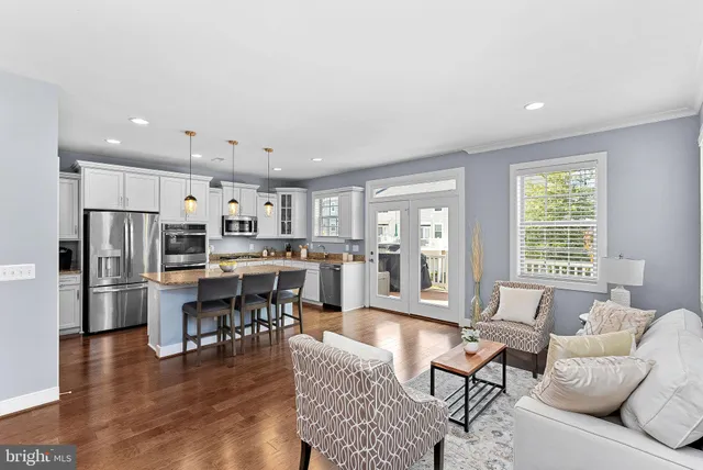 a kitchen with stainless steel appliances granite countertop a sink refrigerator and microwave