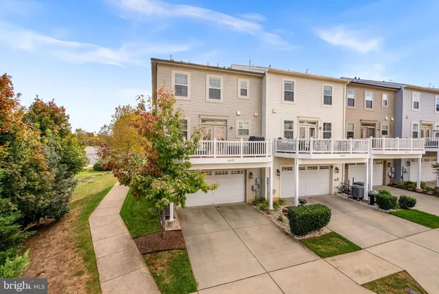 a living room with furniture and a window with balcony view