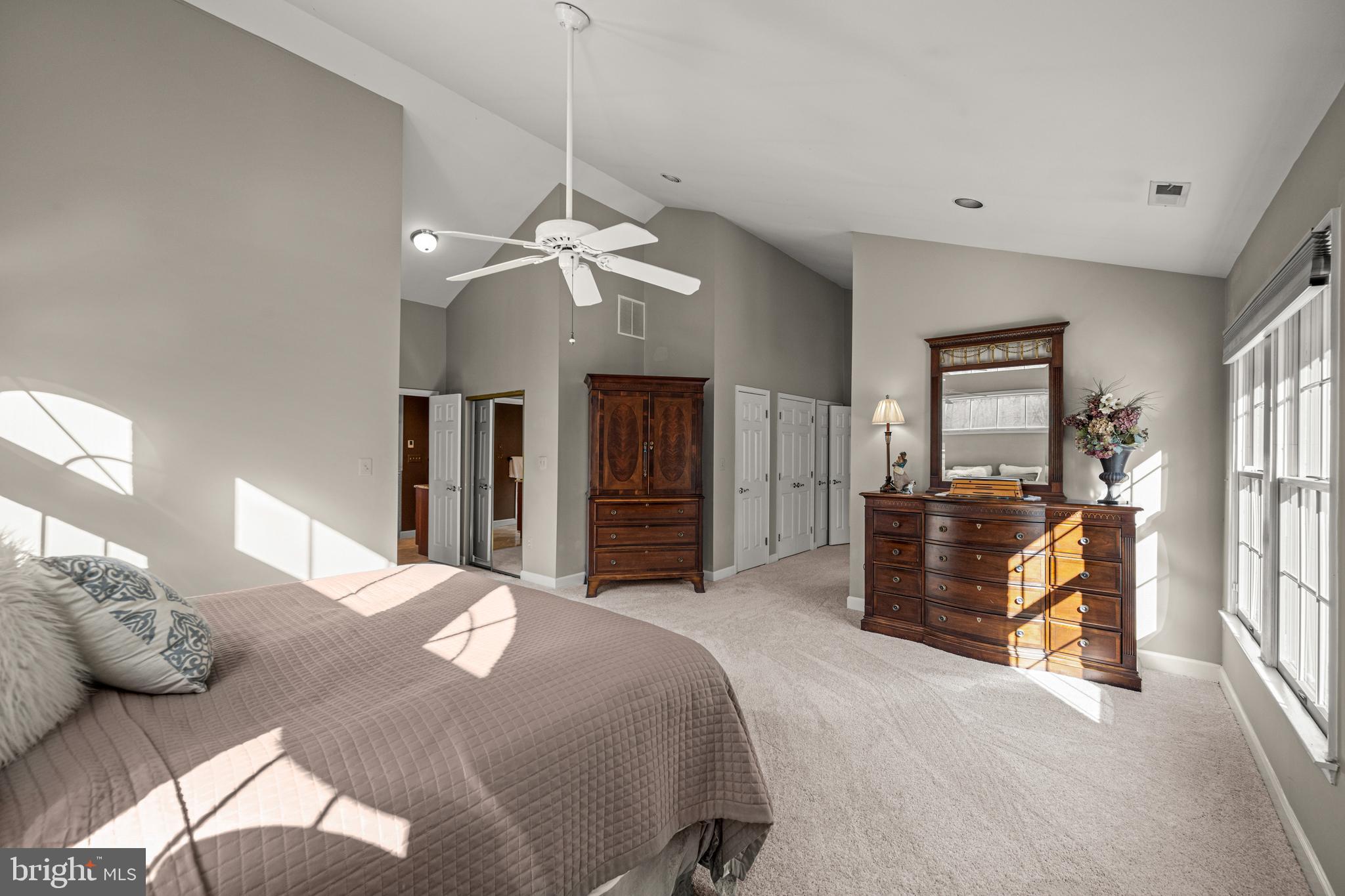 1206 Crystal Ridge Road Marriottsville, MD 21104 - Photo 37 of 72 a bedroom with a large bed and a chandelier