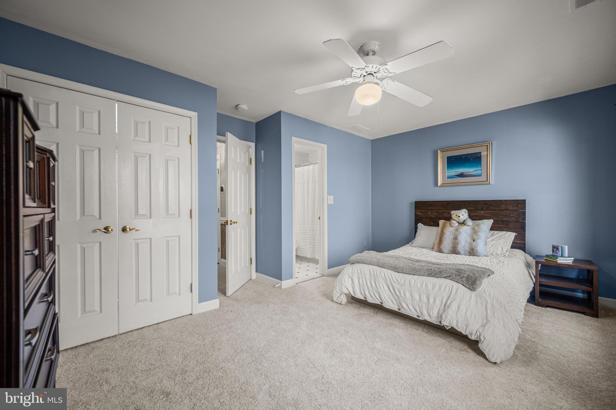 1206 Crystal Ridge Road Marriottsville, MD 21104 - Photo 42 of 72 a bedroom with a large bed and a ceiling fan