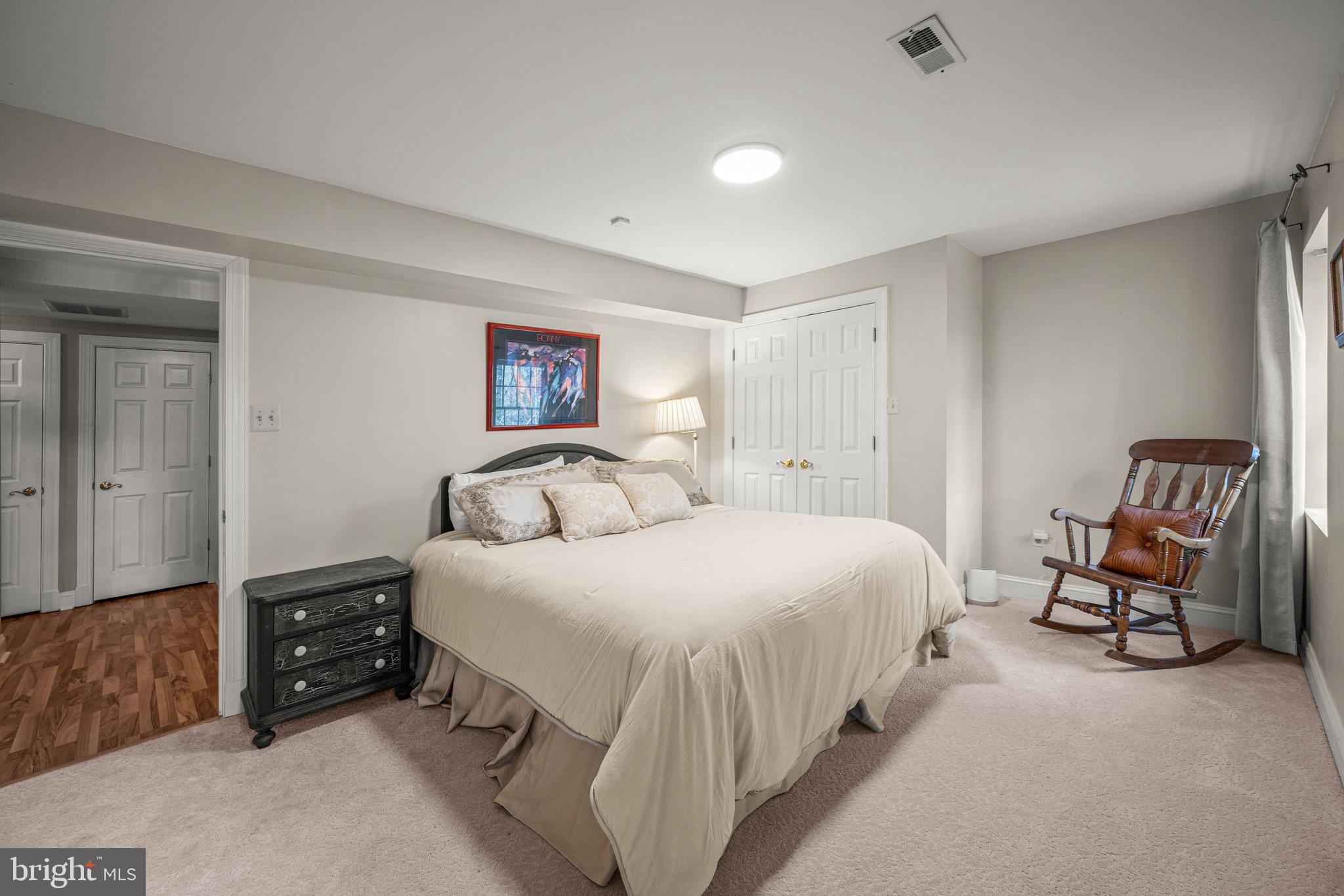 1206 Crystal Ridge Road Marriottsville, MD 21104 - Photo 56 of 72 a bedroom with a bed a chair and next to a window