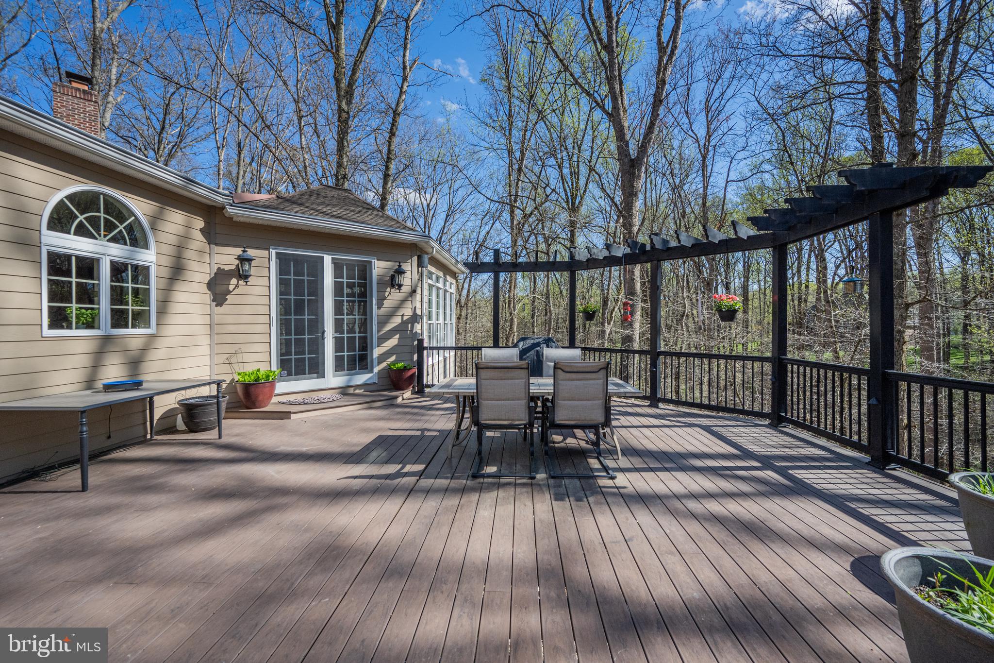 1206 Crystal Ridge Road Marriottsville, MD 21104 - Photo 61 of 72 a view of a patio with table and chairs and wooden floor
