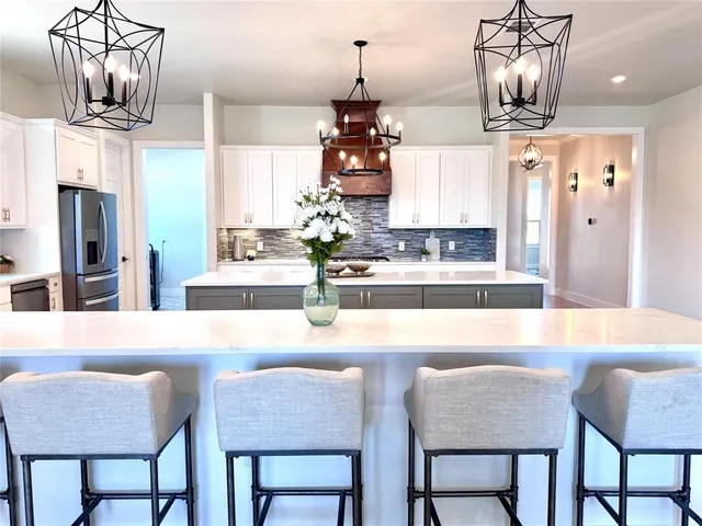 a dining table chair wooden floor and kitchen view