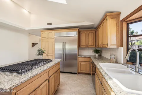 a kitchen with a sink stove and refrigerator
