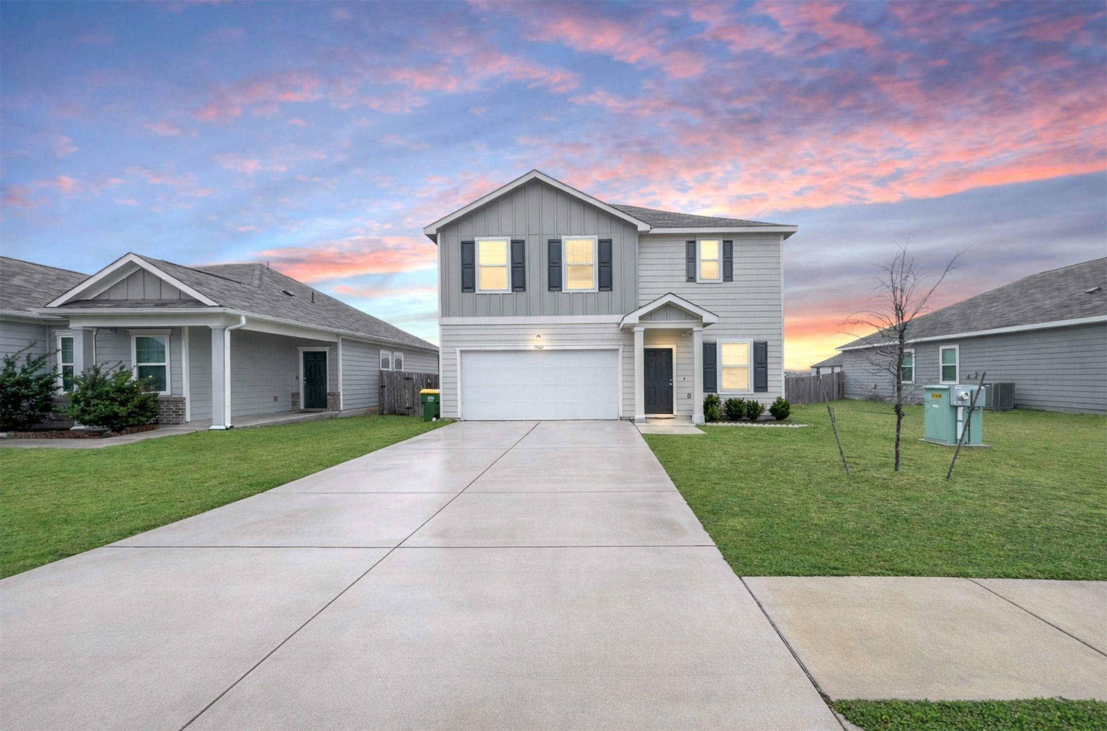 a front view of a house with a yard and garage