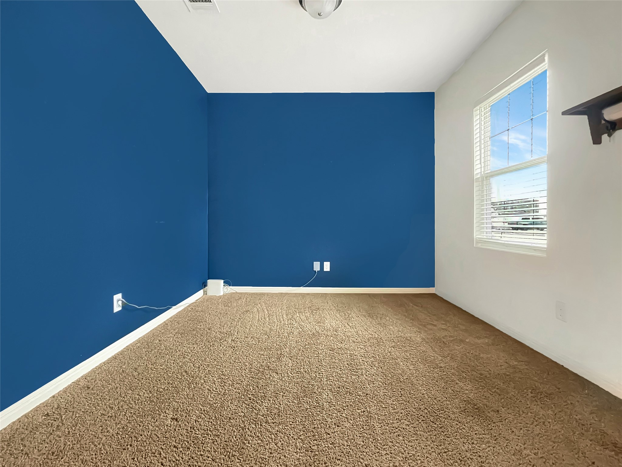 19221 Nathan Scott Way Manor, TX 78653 - Photo 3 of 15 a view of an empty room and a window
