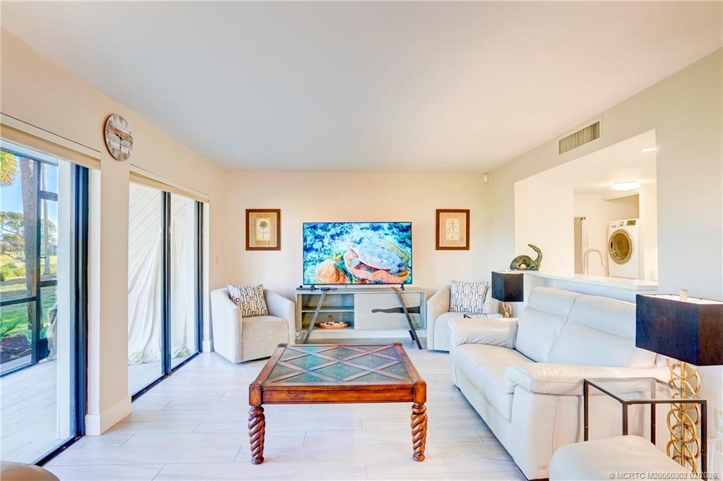 331 Golfview Circle Stuart, FL 34996 - Photo 11 of 48 a living room with furniture a rug and a flat screen tv