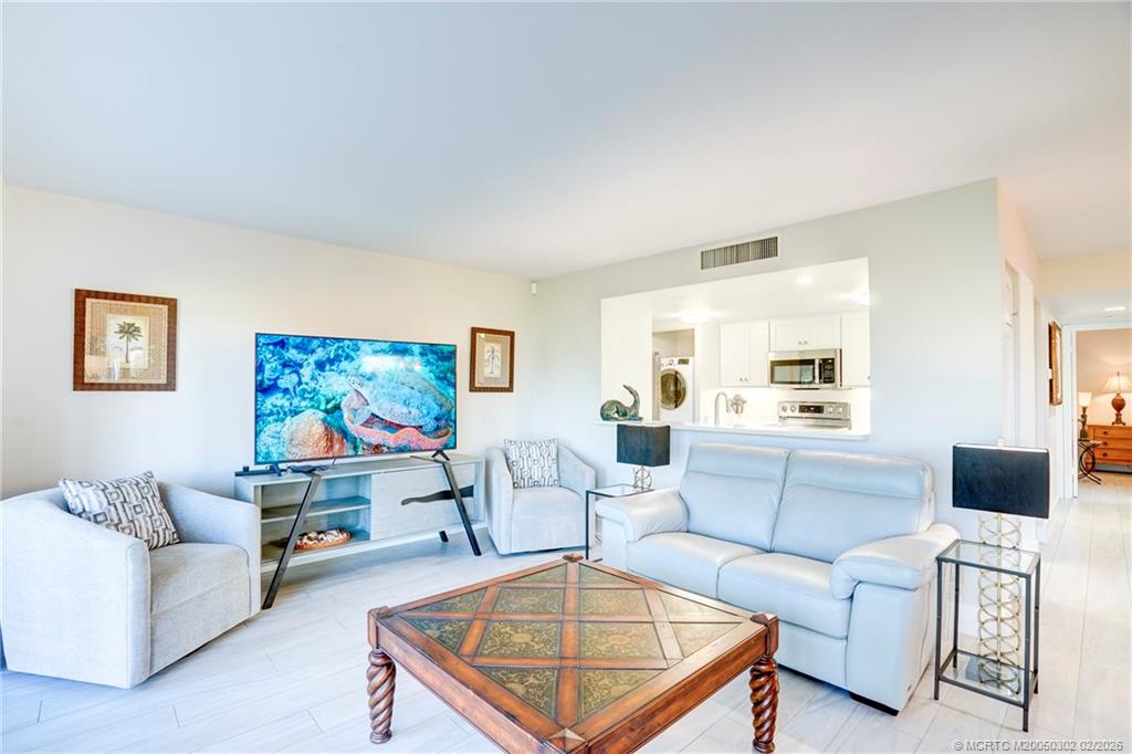 331 Golfview Circle Stuart, FL 34996 - Photo 14 of 48 a living room with furniture and a flat screen tv