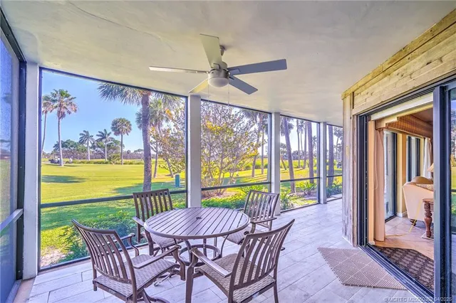 a view of a hallway that has a bed and a table in it