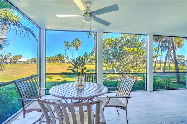a dining room with furniture window and outside view