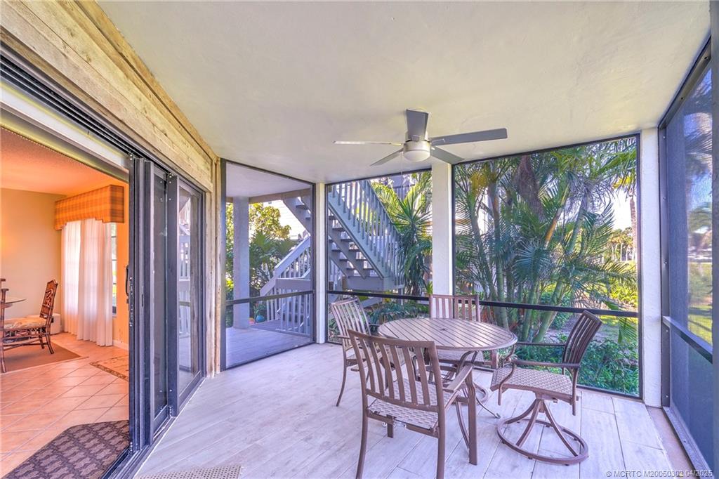 331 Golfview Circle Stuart, FL 34996 - Photo 19 of 39 a dining room with furniture a chandelier and wooden floor