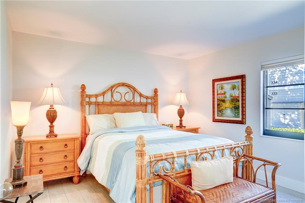 331 Golfview Circle Stuart, FL 34996 - Photo 21 of 48 a bedroom with a bed and a dresser in it
