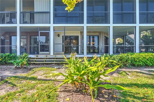 a view of a house with a yard and sitting area