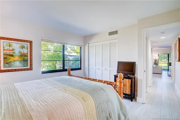 a bedroom with a bed and flat screen tv