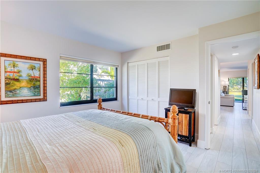 331 Golfview Circle Stuart, FL 34996 - Photo 22 of 48 a bedroom with a bed and a flat screen tv