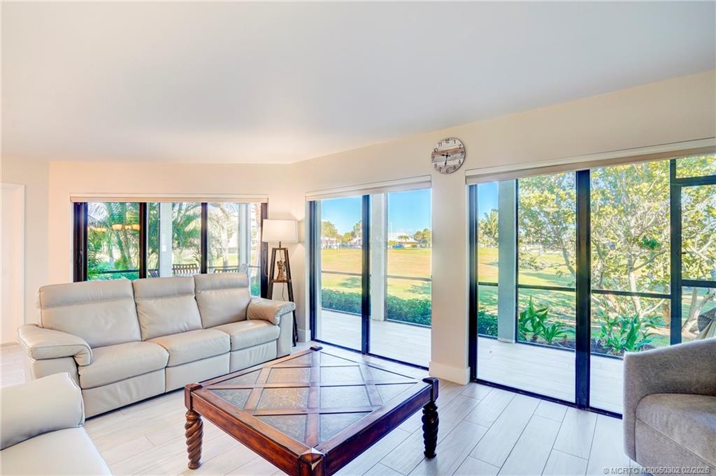 331 Golfview Circle Stuart, FL 34996 - Photo 34 of 48 a living room with furniture and a floor to ceiling window