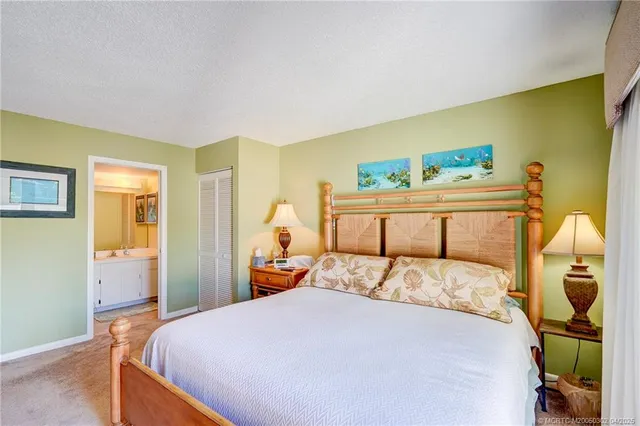 a view of a bedroom with furniture and window
