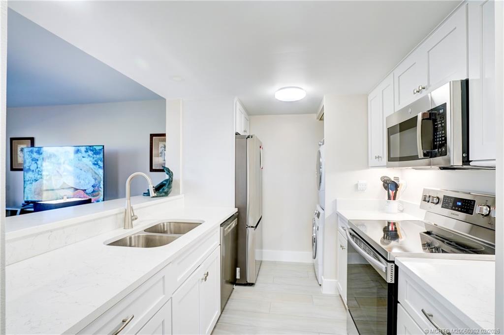 331 Golfview Circle Stuart, FL 34996 - Photo 35 of 48 a kitchen with a sink a stove and refrigerator