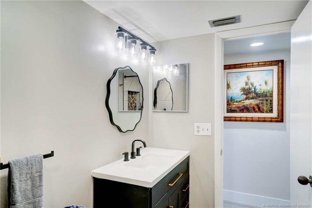 331 Golfview Circle Stuart, FL 34996 - Photo 42 of 48 a bathroom with a sink and a mirror