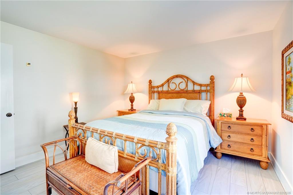 331 Golfview Circle Stuart, FL 34996 - Photo 43 of 48 a bedroom with a bed and wooden floor