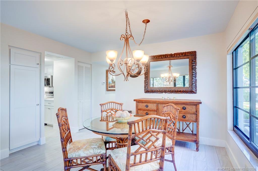 331 Golfview Circle Stuart, FL 34996 - Photo 10 of 48 a view of a dining room with furniture wooden floor and a chandelier