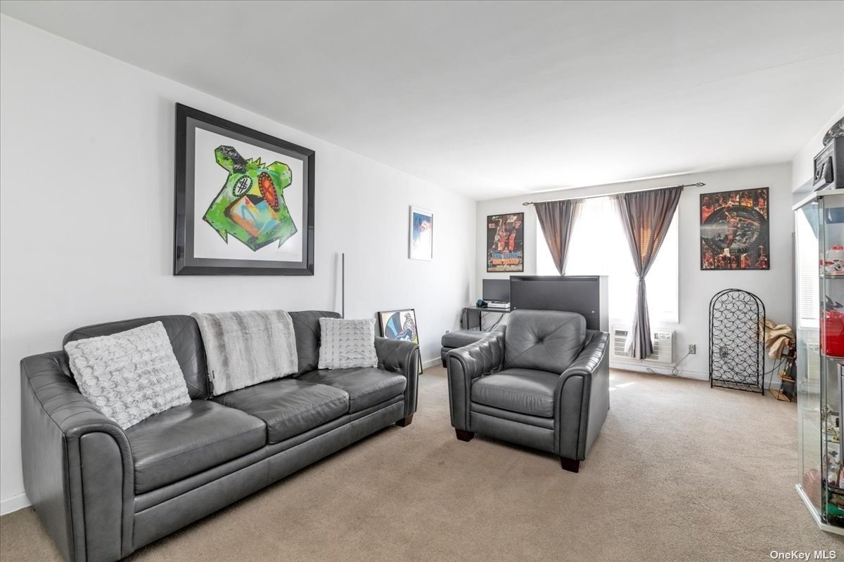 a living room with furniture two couch and a window