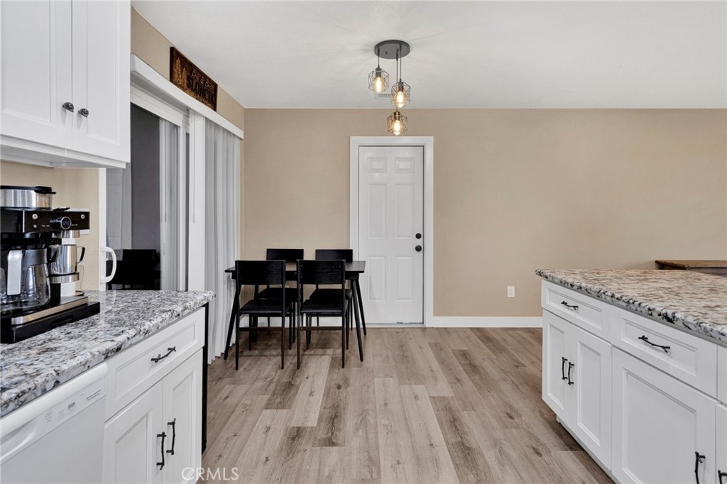 15471 Washoan Road Apple Valley, CA 92307 - Photo 13 of 38 a kitchen with granite countertop white cabinets and appliances
