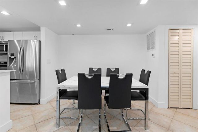 a bed sitting in a bedroom next to a cabinet