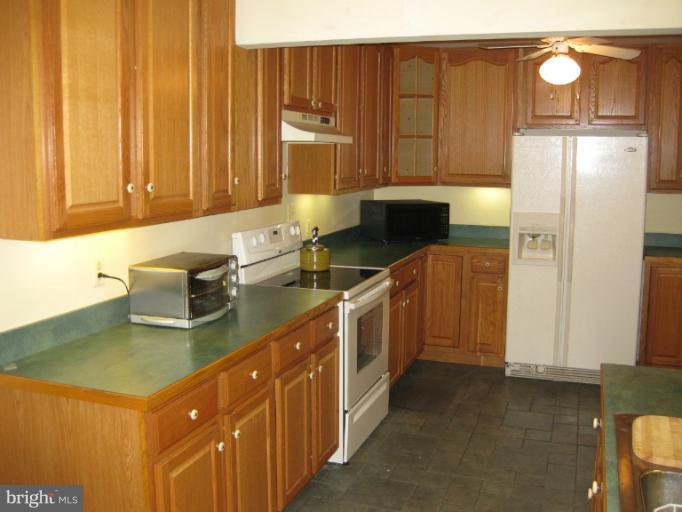 3734 Grave Run Road Manchester, MD 21102 - Photo 13 of 26 a kitchen with kitchen island granite countertop a sink a stove and a refrigerator