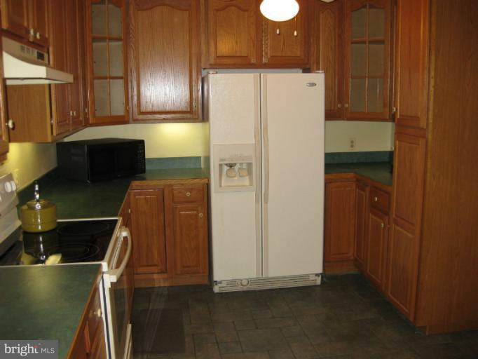 3734 Grave Run Road Manchester, MD 21102 - Photo 14 of 26 a white refrigerator freezer sitting inside of a kitchen