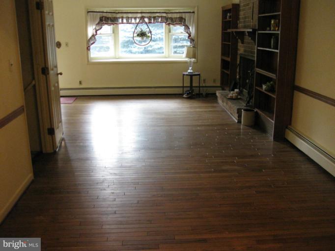 3734 Grave Run Road Manchester, MD 21102 - Photo 15 of 26 an empty room with wooden floor and windows