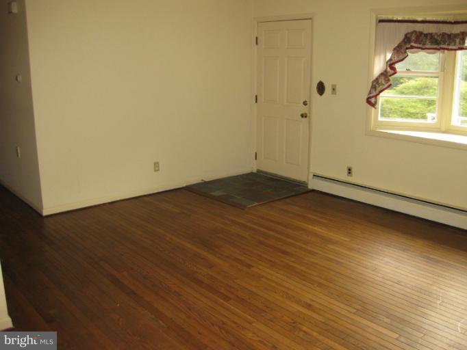 3734 Grave Run Road Manchester, MD 21102 - Photo 25 of 26 an empty room with wooden floor and windows