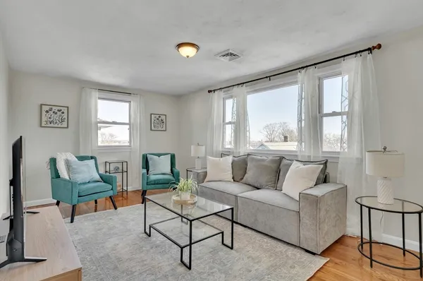 a living room with furniture and a large window