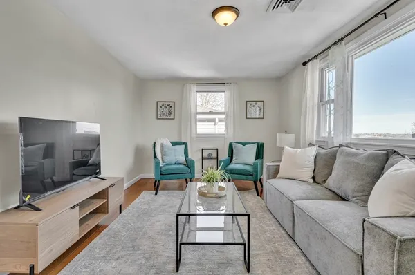 a living room with furniture and a flat screen tv