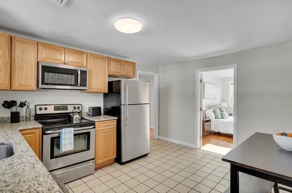 a kitchen with stainless steel appliances granite countertop a refrigerator stove top oven a sink and dishwasher