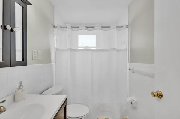 a bathroom with a toilet a sink and shower