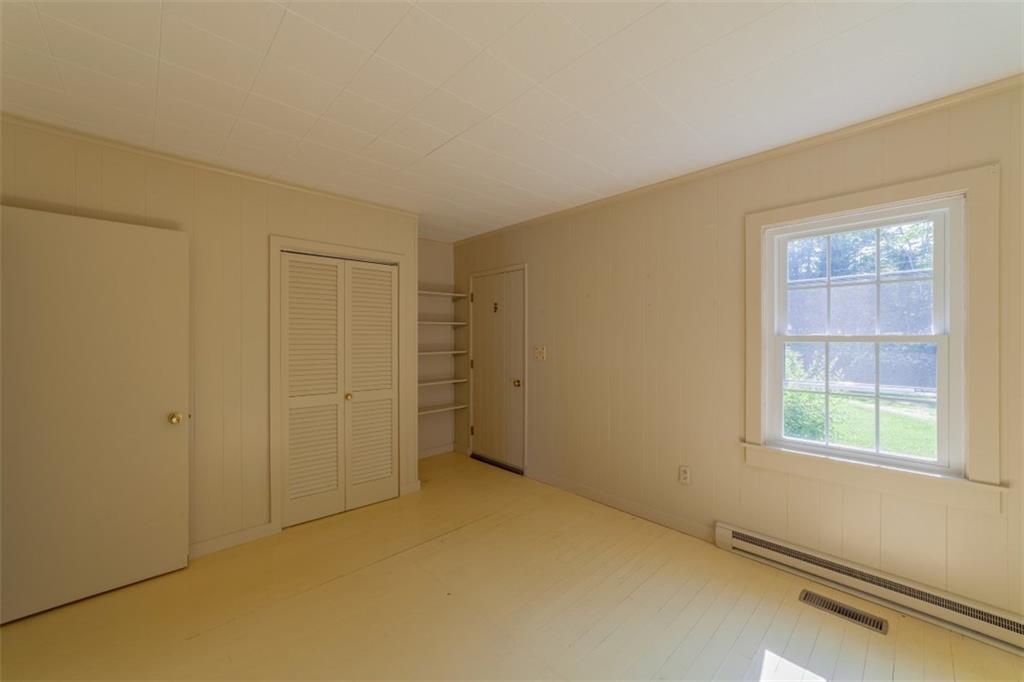 8 Pond Head Road Southport, ME 04576 - Photo 16 of 20 Bedroom with wood paneling, closet,...