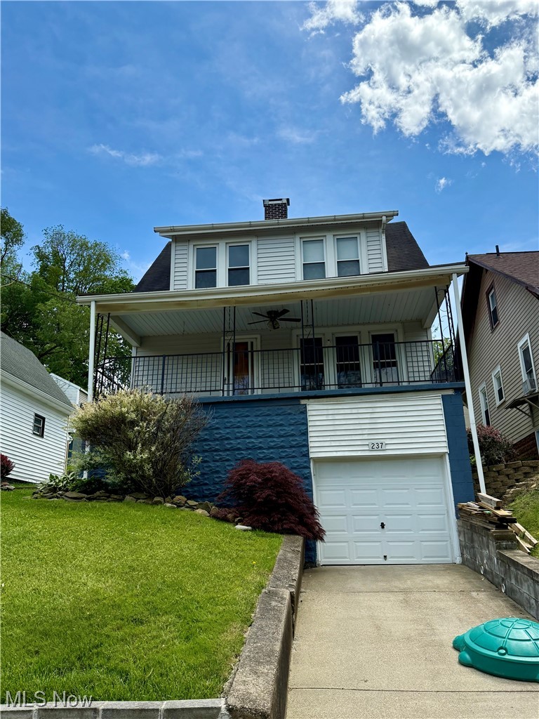 237 Beech Road Weirton, WV 26062 - Photo 2 of 24 View of front facade featuring a front lawn, a garage, a chimney, and concrete driveway