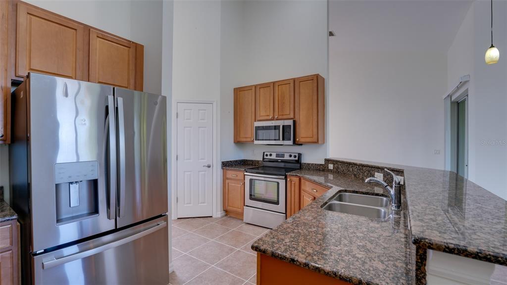 5279 Lovett Road North Port, FL 34288 - Photo 12 of 21 a kitchen with stainless steel appliances granite countertop a refrigerator stove and oven