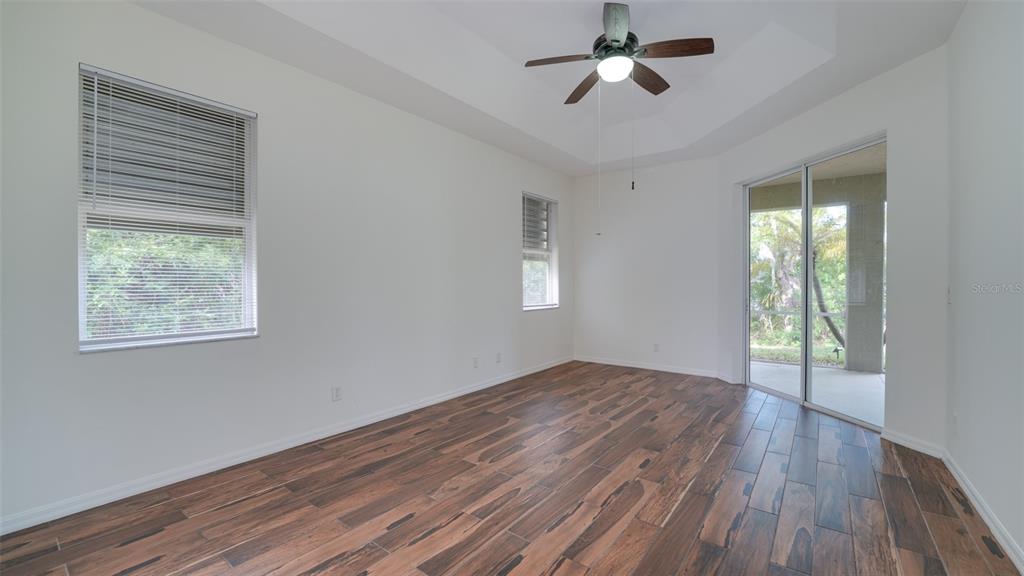 5279 Lovett Road North Port, FL 34288 - Photo 13 of 21 a view of an empty room with wooden floor and a window