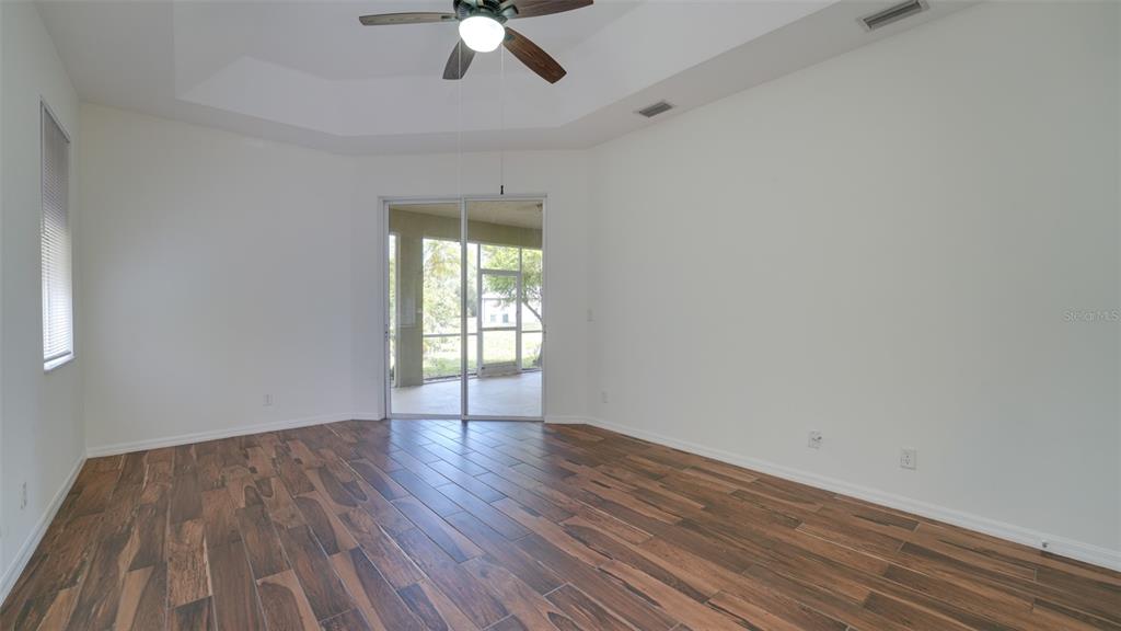5279 Lovett Road North Port, FL 34288 - Photo 14 of 21 a view of an empty room with wooden floor and a window
