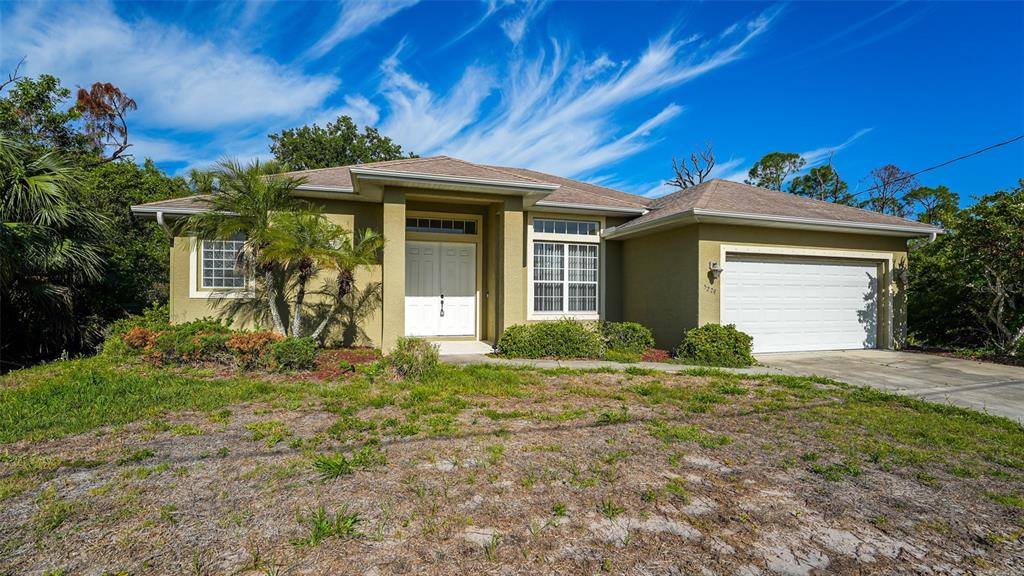 5279 Lovett Road North Port, FL 34288 - Photo 2 of 21 a front view of a house with garden