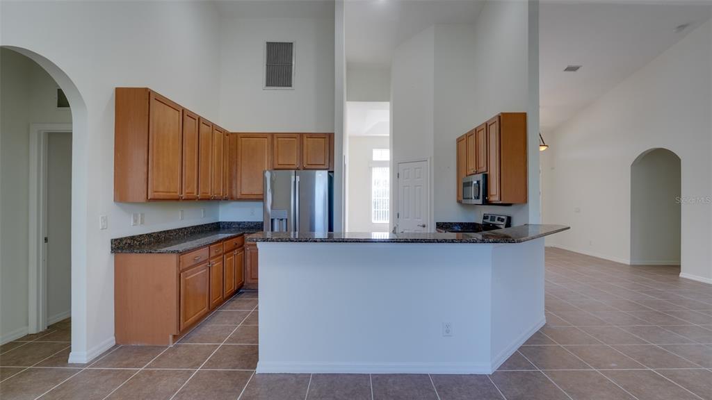 5279 Lovett Road North Port, FL 34288 - Photo 10 of 21 a kitchen with stainless steel appliances granite countertop a sink and a stove